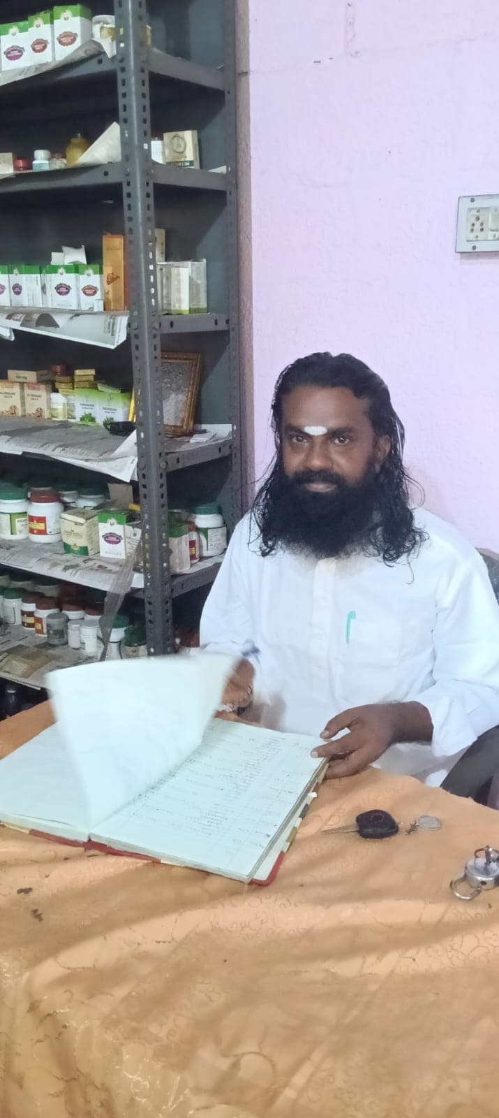Vaidyar Shine Bhaskar consulting a patient